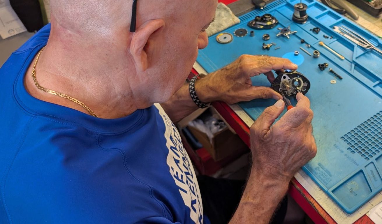 Capt. Jerry Sersen working on a reel at his bench