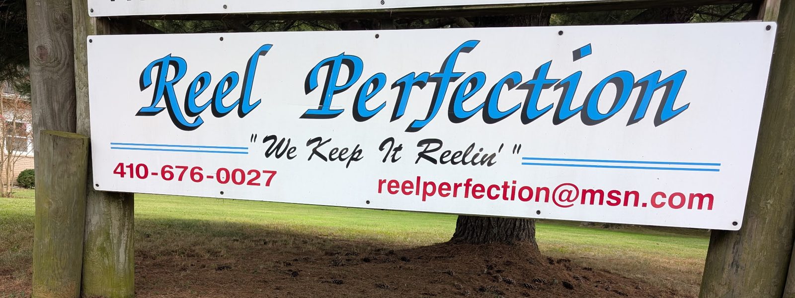The Reel Perfection sign at the entrance: We Keep It Reelin', 410-676-0027